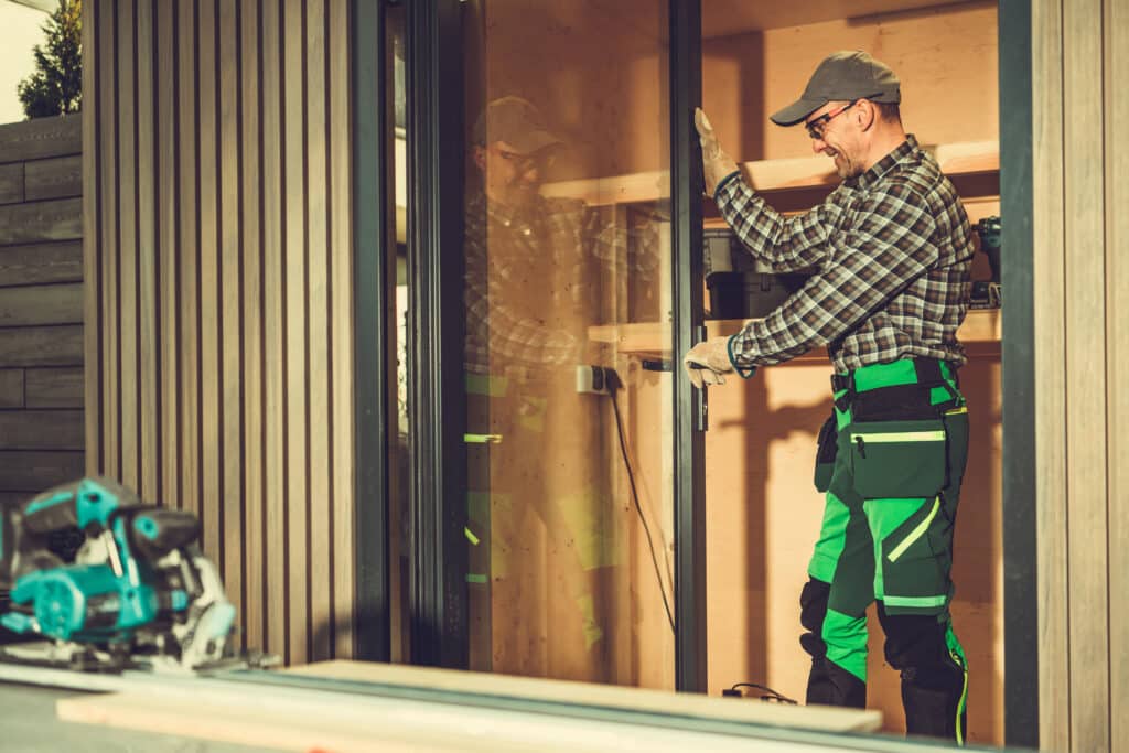 window & door contractor installing sliding glass door