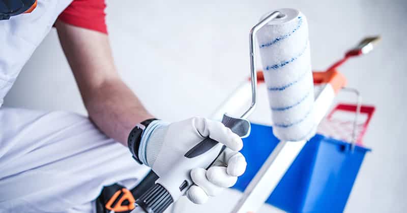 close up of a painter holding a roller