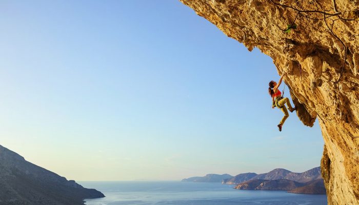 Woman climbing a rocky hill